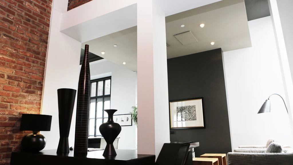 Tribeca Loft with cast-iron columns and a long blackened steel and oak millwork wall
